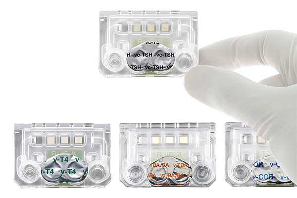 [photo] FUJI DRI-CHEM IMMUNO AU10V with a hand holding up one