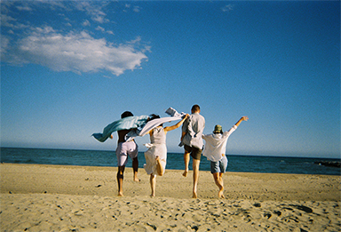 Photo of back view of four friends taken by “QuickSnap™”
