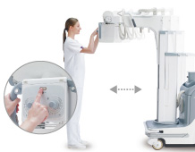 [photo] Healthcare professional in front of machine, able to move it forward and backward