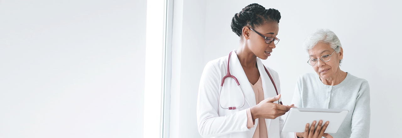 a doctor who explains something to an elder woman