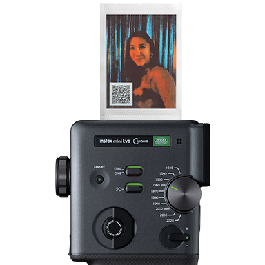 instax mini Evo™ printing instax photos™ with a QR code.