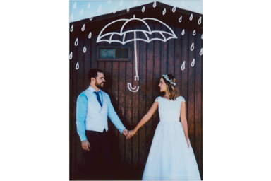 Umbrella filter picture of the young couple in wedding attire