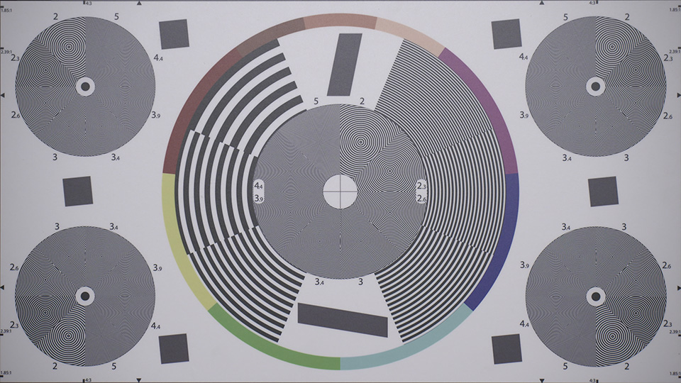 [photo] One big circle and 4 smaller circles with wavy lines on a lens test chart 