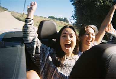 Photo of two women enjoying a drive, taken with “QuickSnap™”