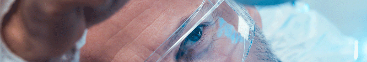 An engineer examines a piece of equipment