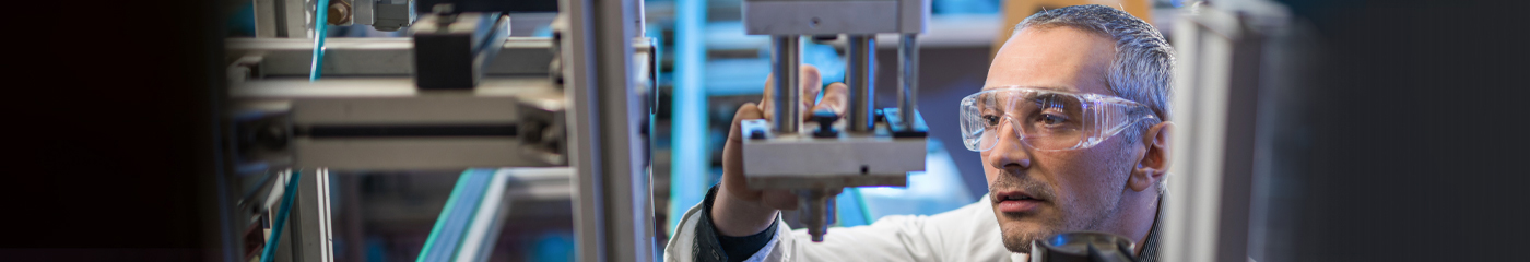 Engineer quality testing a piece of machinery