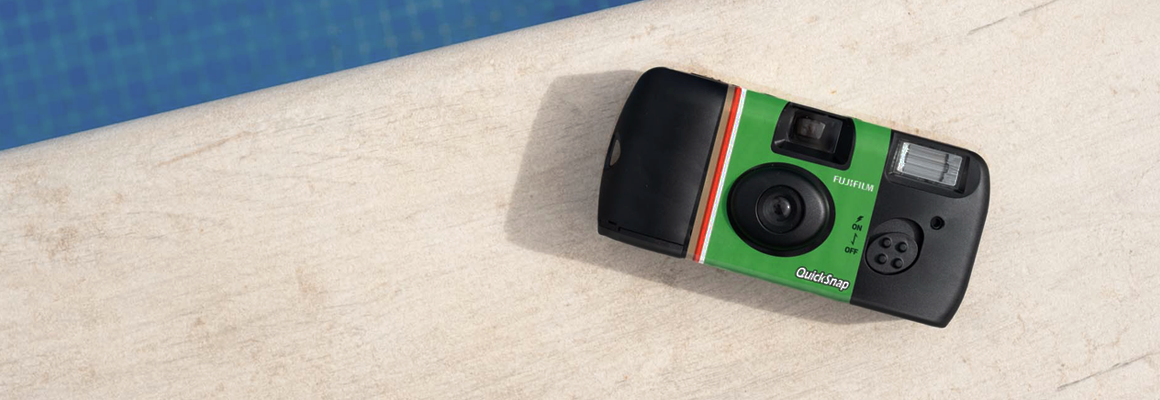 quicksnap camera lying on a stone slab