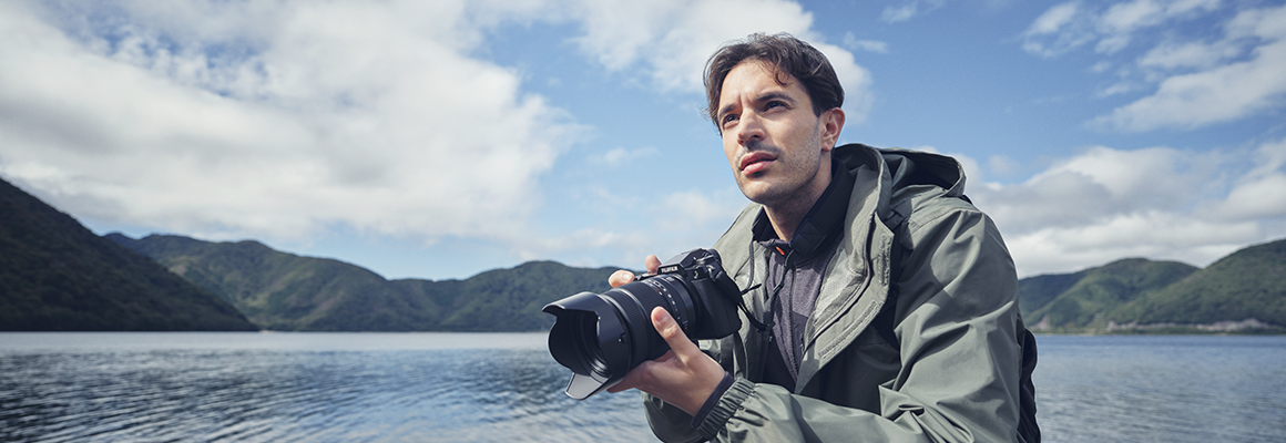 Young man with a Fujifilm camera in his hand