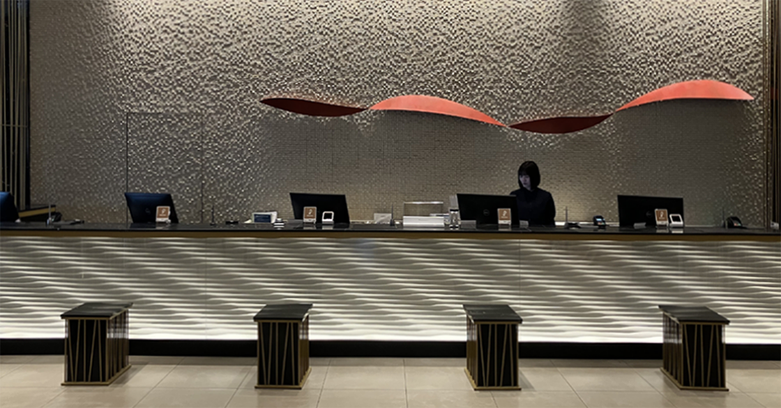 ホテルの受付に透明翻訳ディスプレイ「VUEVO Display」を設置している様子