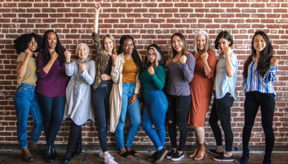 Image of a group of women in front of a brick wall