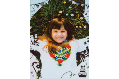 [photo] Party frame added to a photo of a young girl smiling at the camera while playing outside