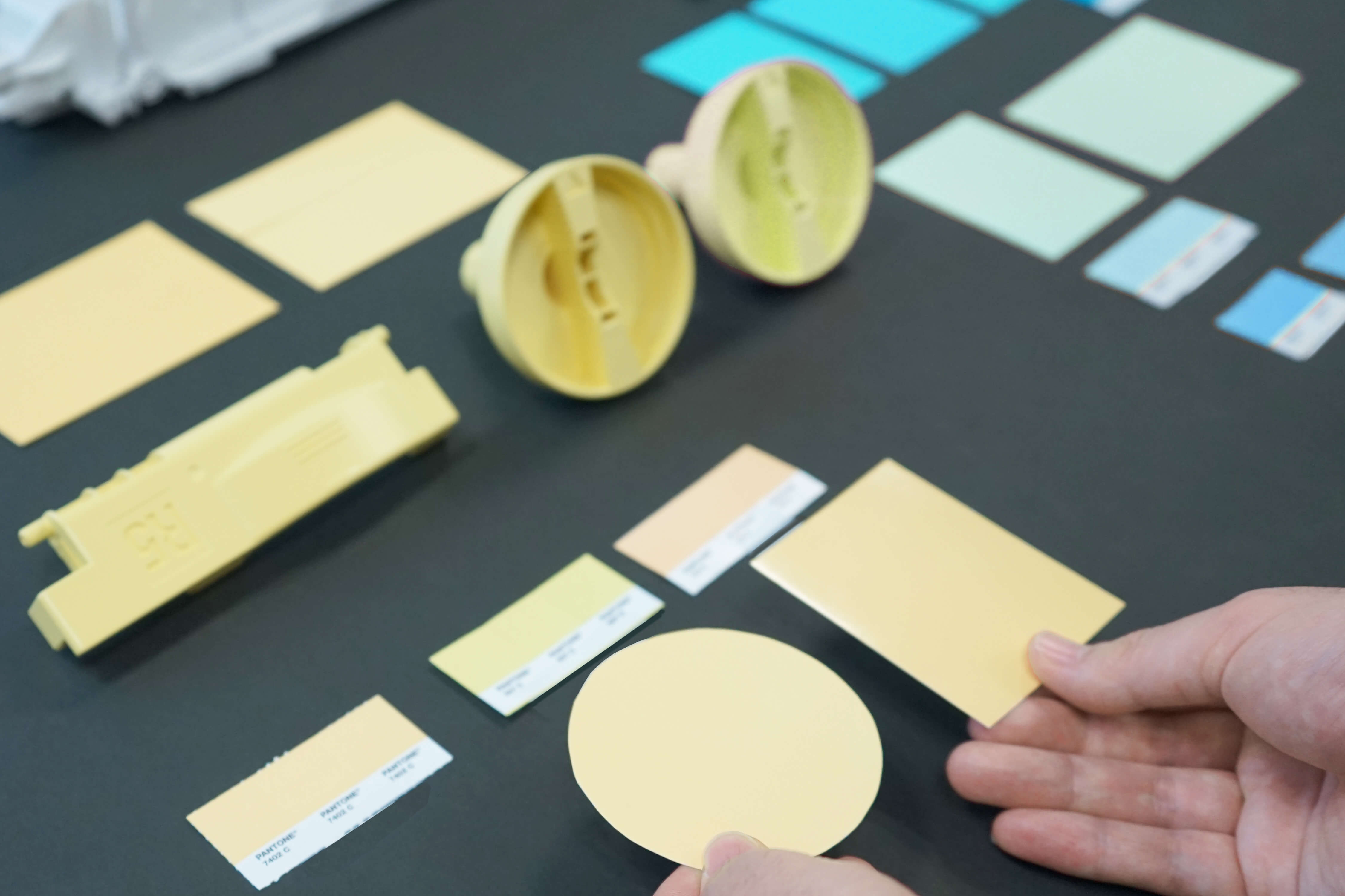 Various colored paint samples arranged on a desk.