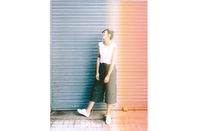 [photo] Light FX frame added to a photo of a girl standing in front of a ribbed warehouse gate