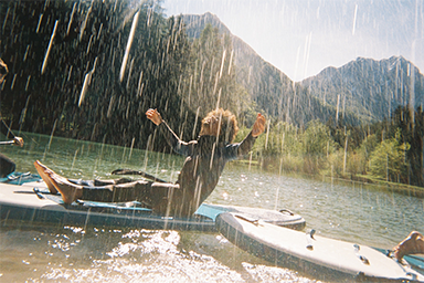 People enjoying a canoe ride with water splashing around