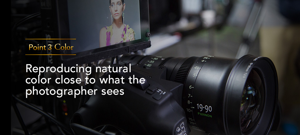 [photo] "Point 3 Color: Reproducing natural color close to what the photographer sees" text with a front view of a digital camera and an external display monitor showing the lady subject in the frame