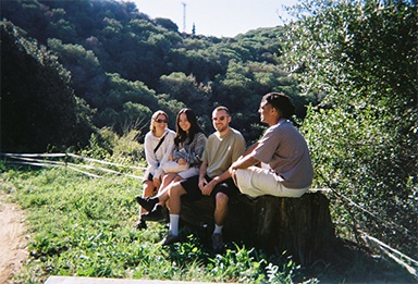 Photo of four friends chatting, taken with “QuickSnap™”