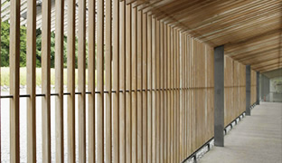 [photo] A wooden fence and roof over a hallway highlighting the horizontal and vertical lines distortion using the FUJINON 19-90mm/F8 ZK Series lens