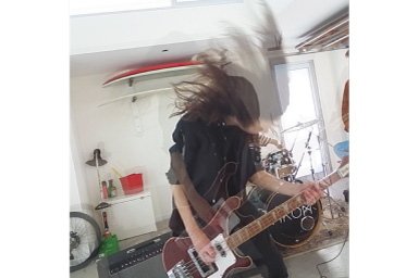 Image of persons playing guitar with Sequence filter applied