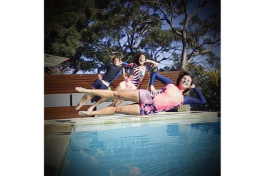 Image of three persons jumping into the pool with black vignette