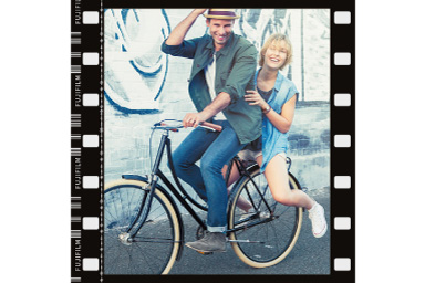 Image of a man and woman on a bicycle with Film Frame filter applied