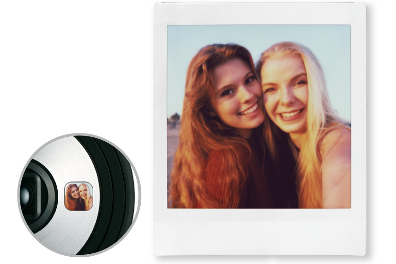 Image of a close-up SQ6 selfie mirror reflecting two women and a photo of two women