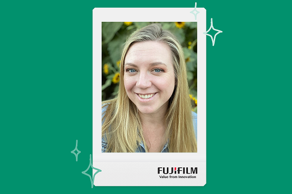 a woman smiles in a photo framed by an instax print frame