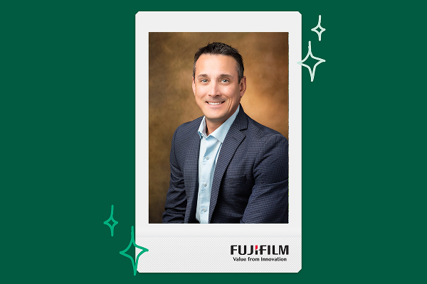 a man in a suit poses for a headshot