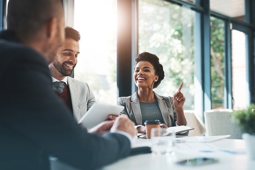 a group of colleagues chat around a table