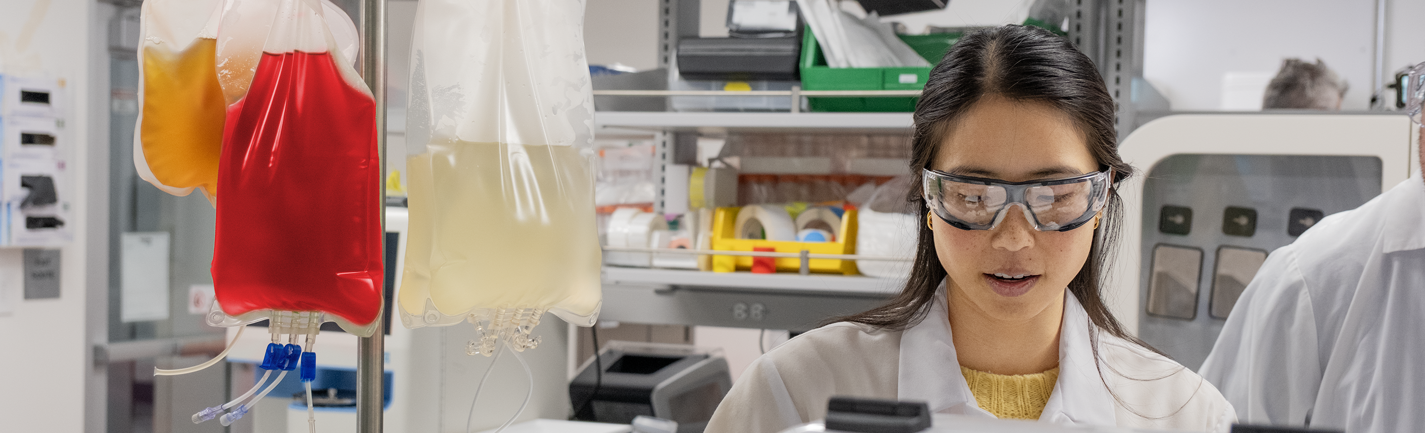 woman wears protective glasses in a laboratory