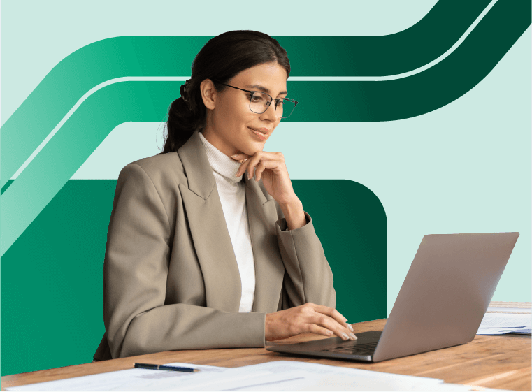 woman sits at a table working on a laptop