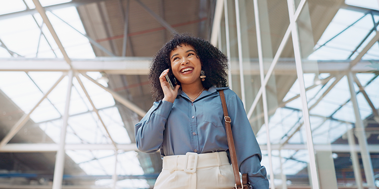 a woman talks on a phone in a hallway