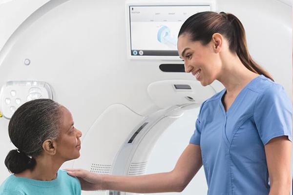 A doctor and a patient talking in front of testing system